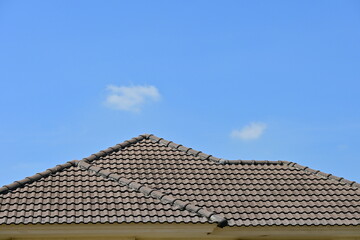 grey roof tile of house on blue sky and white cloud background