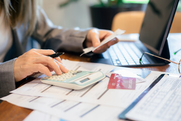 Woman is checking credit card bill information at office