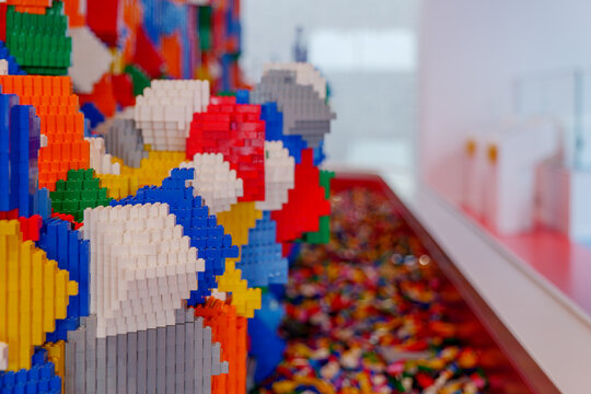 Selective focus at colorful vertical stack wall of lego blocks in Billund, Denmark.