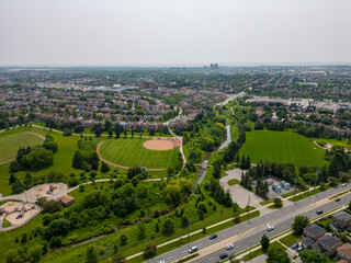 Fototapeta na wymiar Stunning drone photo capturing the pristine green grass and beautiful homes along Kingston Road Westney. An exceptional view of Ajax real estate at its fines