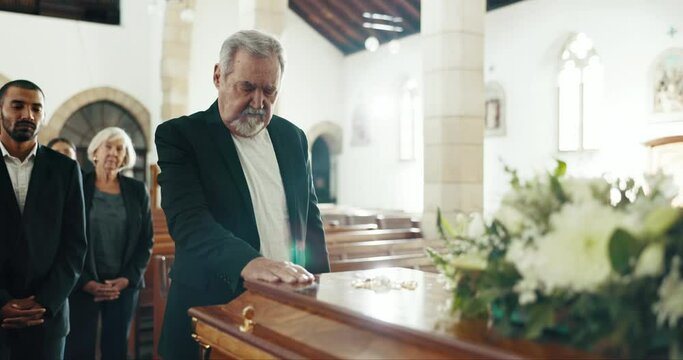 Funeral, church and man by coffin for mourning. goodbye and grief in memorial service. Depression, family and sad male person with casket in chapel for greeting, loss comfort and burial for death