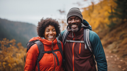 Middle age african-american couple hiking in the fall