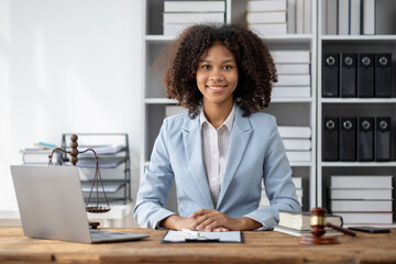 American woman is legal litigation attorney, Female lawyer is in a law firm drafting contracts and reading client case details to study and find a solution to win the case. Lawyer and justice concept.