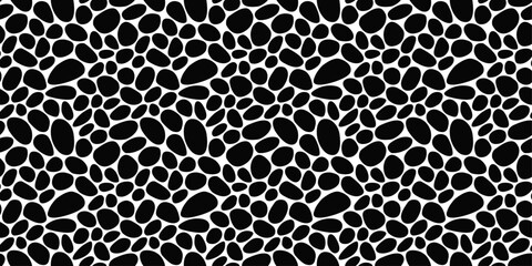 Seamless pebbles resembling a leopard skin. The black stones are rounded and provide texture. Pattern of black pebbles.