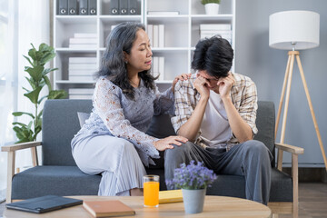 Loving elderly mother comforting worried concerned adult son, giving support, compassion, empathy.