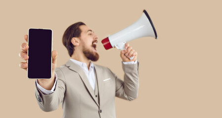 Wide narrow shot of man scream make announcement on loudspeaker about sale online on mobile phone....