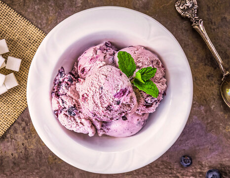 Blueberry homemade ice cream on stone slate background