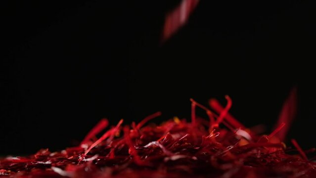 Saffron threads spice are falling down a pile of many Saffron threads. Saffron (Crocus sativus) may provide pain relief