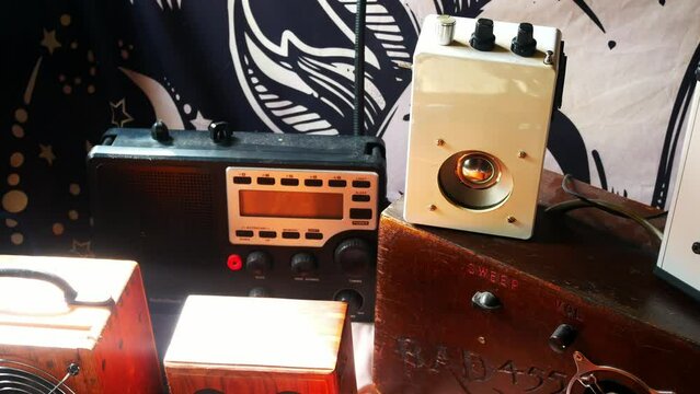 Panning across modern collection of paranormal ghost box EVP communication devices