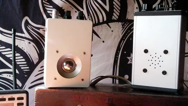 Modern collection of paranormal exploration ghost box EVP communication devices, dolly right shot