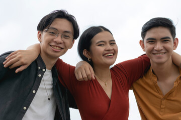 Three young asian friends, 2 male and one female in between them. One male best friend and one her...