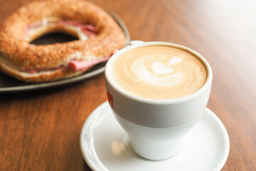 a cup of late coffee with flower shape design on top at cafe 