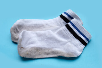 Dirty white socks on blue background.