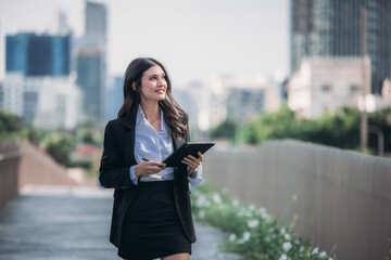 Fototapeta premium Confident woman leads, showcasing exceptional leadership, strategic thinking, overseeing daily operations with her tablet.