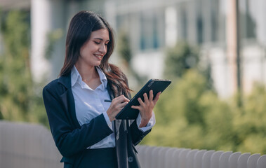 Fototapeta premium Confident woman leads, showcasing exceptional leadership, strategic thinking, overseeing daily operations with her tablet.