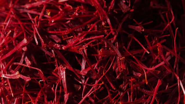 Macro filming of upper part of many Saffron threads heap. A pile of Saffron threads rotating. Saffron (Crocus sativus) helps enhance memory