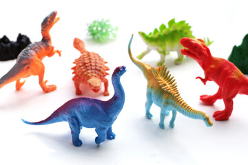 Plastic dinosaur toys on white background.