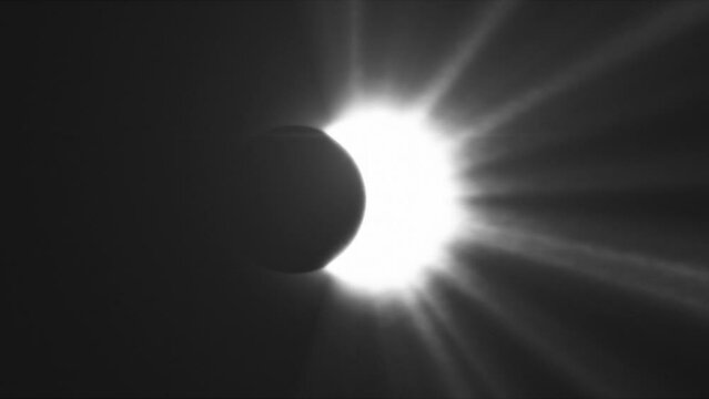 Sun rays of light, moon covering the sun during Total Solar Eclipse, Black and white.
