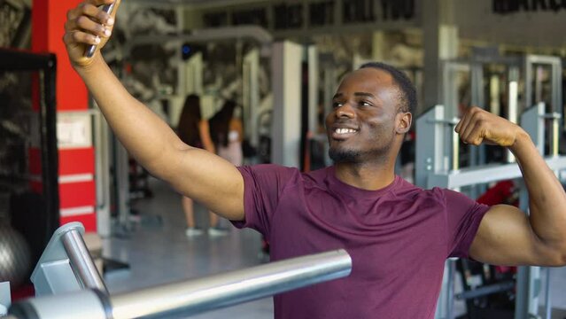 Black man, strong and fitness selfie, gym and exercise portrait, after workout and weight training, happy and flexing arm. Cardio, endurance and smile, sweat for sport and bicep photo, wellness.