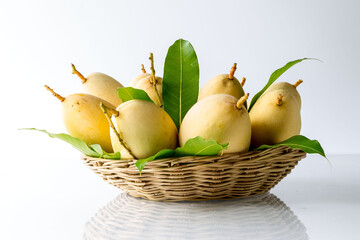 Organic Nam Dok Mai thai Mangoes and leaves in basket, Sweet, tasty, refreshing.It is the most popular mangoes variety in Thailand. concept vitamin from fruit and  information in supermarket.