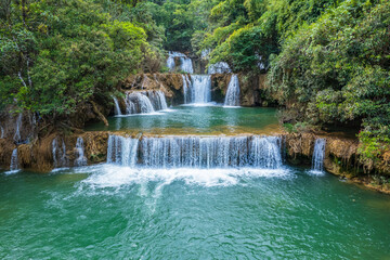 Obraz premium Beautiful waterfall in middle of the rainforest at Tak province, Thailand.