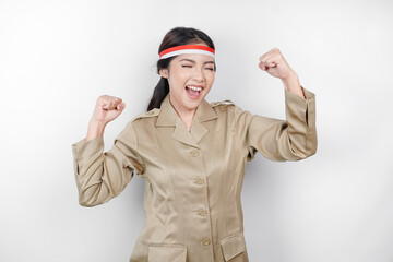 A young Asian government worker with a happy successful expression, wearing flag headband and khaki...