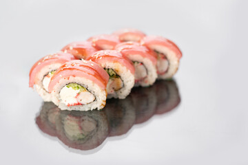 Japanese sushi rolls with tuna, king prawn and cream cheese on a white isolated background