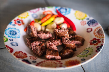 Isaan sausages with fresh chilli and garlic in a white floral plate
