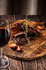 American cuisine, glazed fried ribs in honey and soy sauce lie on a wooden board. background image for the menu.