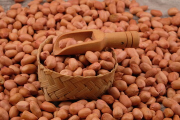 raw peanuts in a bamboo basket. Peanut is a leguminous plant belonging to the Fabaceae tribe that is cultivated. Arachis hypogaea. vegetable protein, calcium, magnesium, iron. kacang tanah mentah.