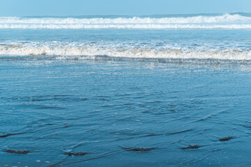 The wave in the sea with blue sky background in Yogyakarta, Indonesia