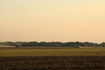 Harvesters working in the field on a hot summer day