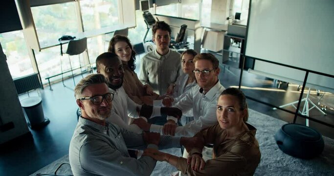 Pov: group therapy of trust. A group of people in business uniforms are waiting for a person to fall into their arms. Trust therapy in the office