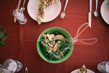 A top down view of salad on finely decorated table.