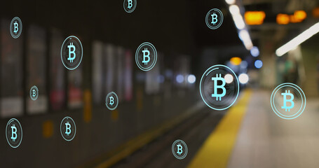 Image of multiple bitcoin symbols floating against blurred view of train arriving at a station