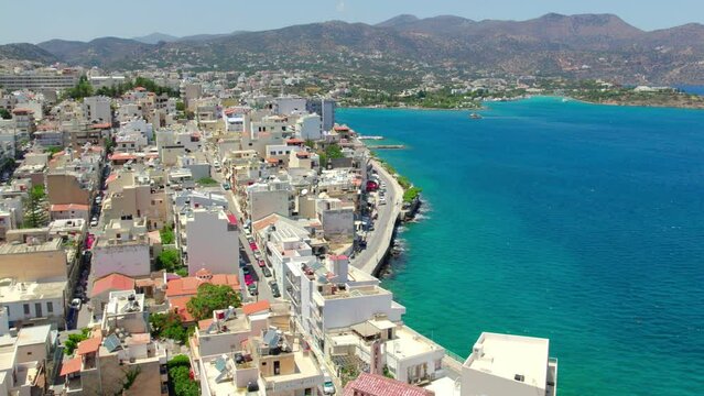 A slow-motion aerial view of Agios Nikolaos on the Greek island of Crete. Drone circling around the port.