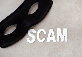 Scammers everywhere. Scam in lettering with mask on grey