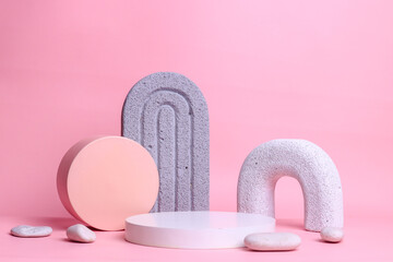Abstract background with various geometric shapes in pink pastel color for product presentation. Podium to show cosmetic products.