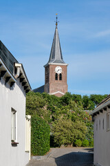 Fototapeta na wymiar View of the 13th century Romano-Gothic Godeharduskerk in Marrum Friesland The Netherlands. The church was dedicated to Godehardus van Hildesheim.