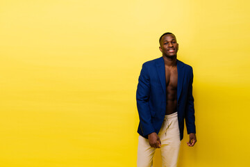 Laughing single handsome young African man over red yellow background with copy space