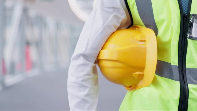 Construction worker, helmet and engineering, maintenance and renovation with contractor person at job site. Safety, protection and hard hat with architecture, mockup space and building industry