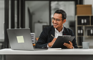 Handsome Asian businessman of Indian descent working at desk, digital asset exchange license, the...