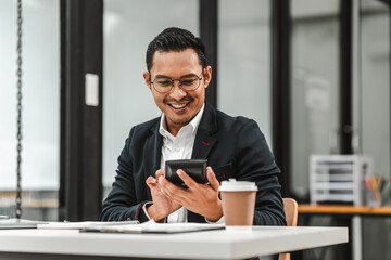 Handsome Asian businessman of Indian descent working at desk, digital asset exchange license, the world's largest cryptocurrency exchange by trading volume, registered recognized market operators