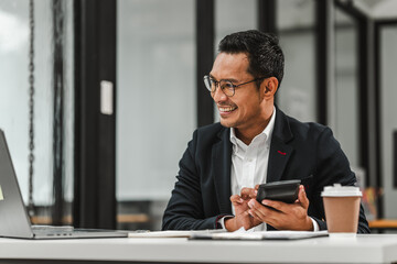 Handsome Asian businessman of Indian descent working at desk, digital asset exchange license, the...