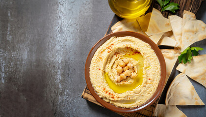 Healthy homemade hummus with olive oil and pita chips. Top view