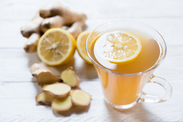Ginger tea on white table with lemon