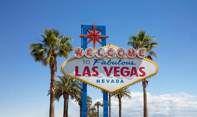 Welcome to Fabulous Las Vegas Nevada Sign. Palm tree behind neon billboard, USA casino, blue sky.