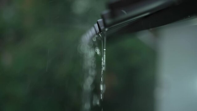 beautiful nature
heavy summer downpour
Streams of water flow from the roof of the porch
weather for home relaxation
handheld, live camera