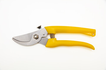 Garden pruning shears closed yellow handle isolated on white background, top view