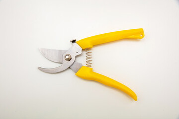 Garden pruning shears open yellow handle isolated on white background, top view